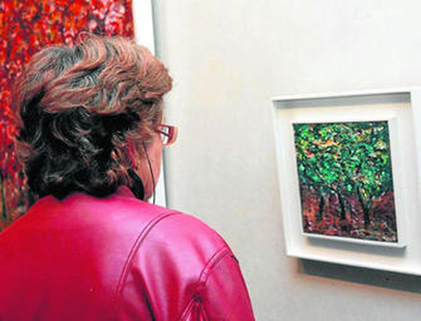 Una mujer observa uno de los cuadros que se exponen desde ayer en Huelva.