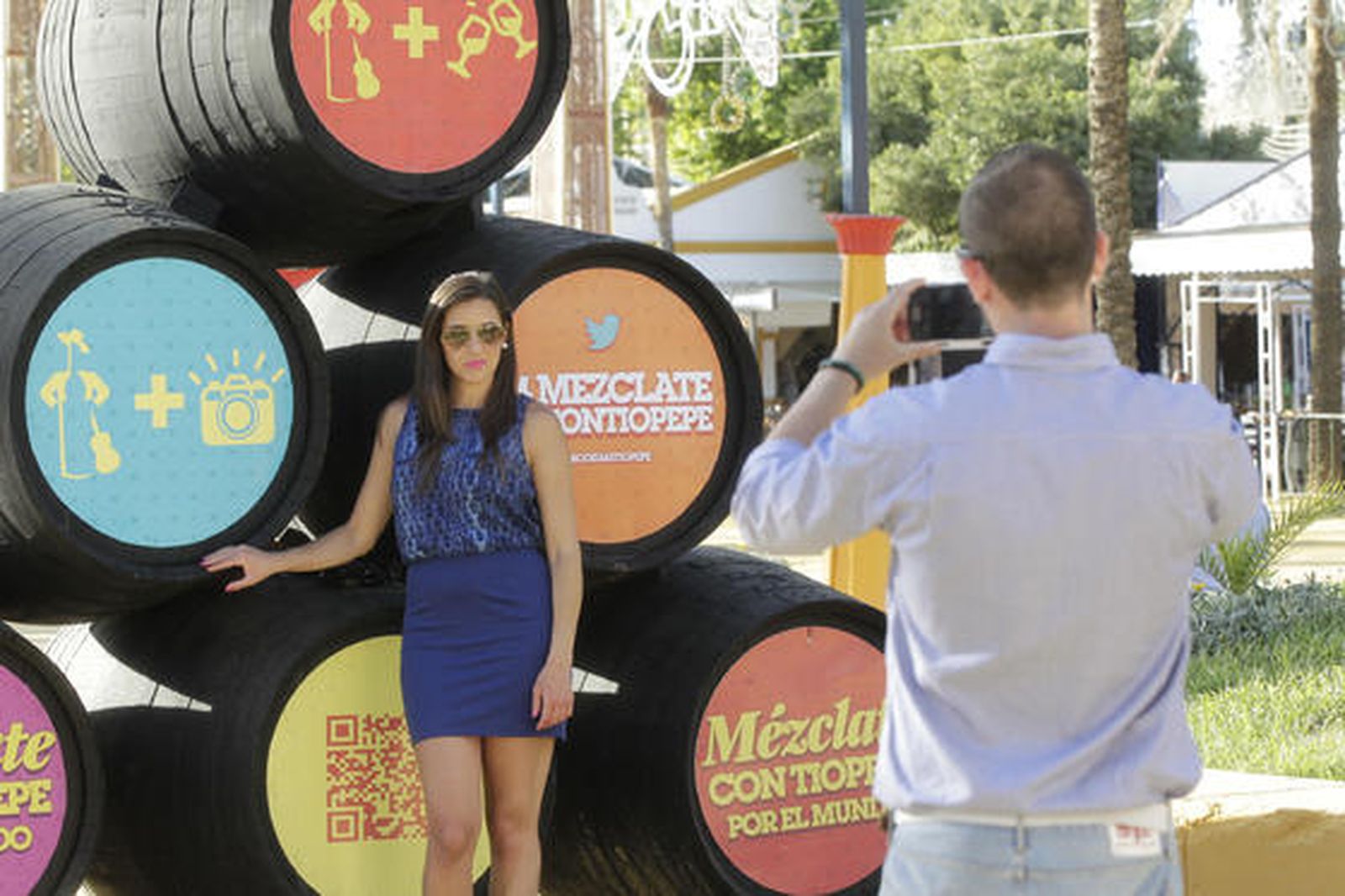 Dos visitantes, móvil en mano, haciéndose una fotografía delante de unas botas de Tío Pepe

Foto: Miguel Angel Gonzalez