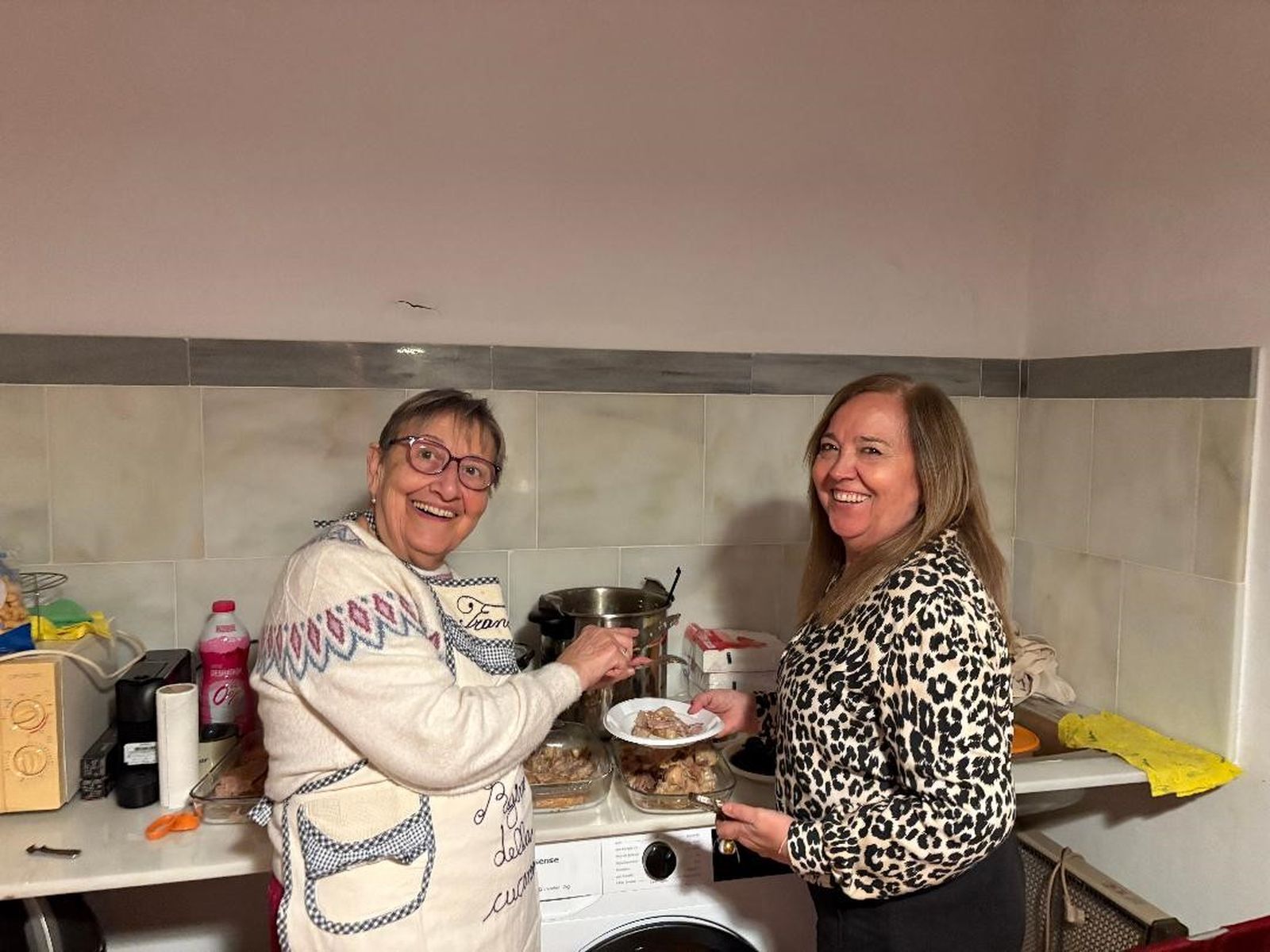 Paqui Cea con Encarna Díaz, sirviendo  la histórica Berza Navideña.