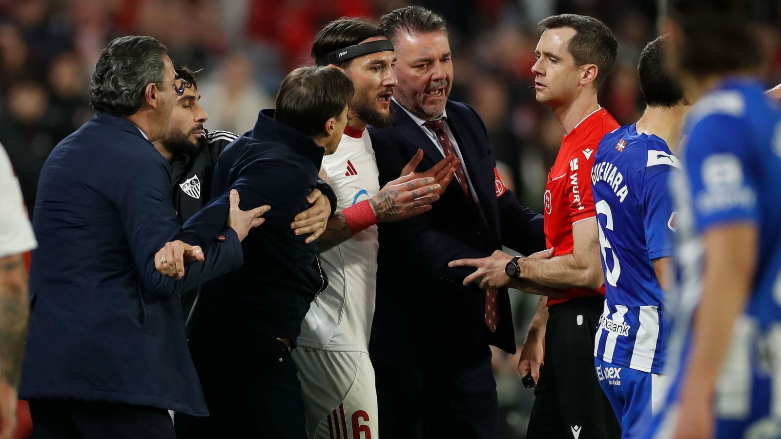 Almeyda siendo sujetado por Maupay y un miembro del Sevilla FC.