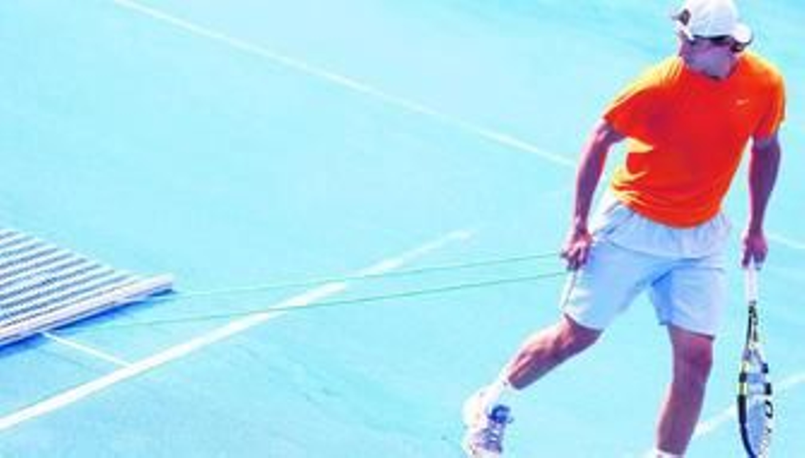 Nadal prepara la pista durante el entrenamiento de ayer en la Caja Mágica.
