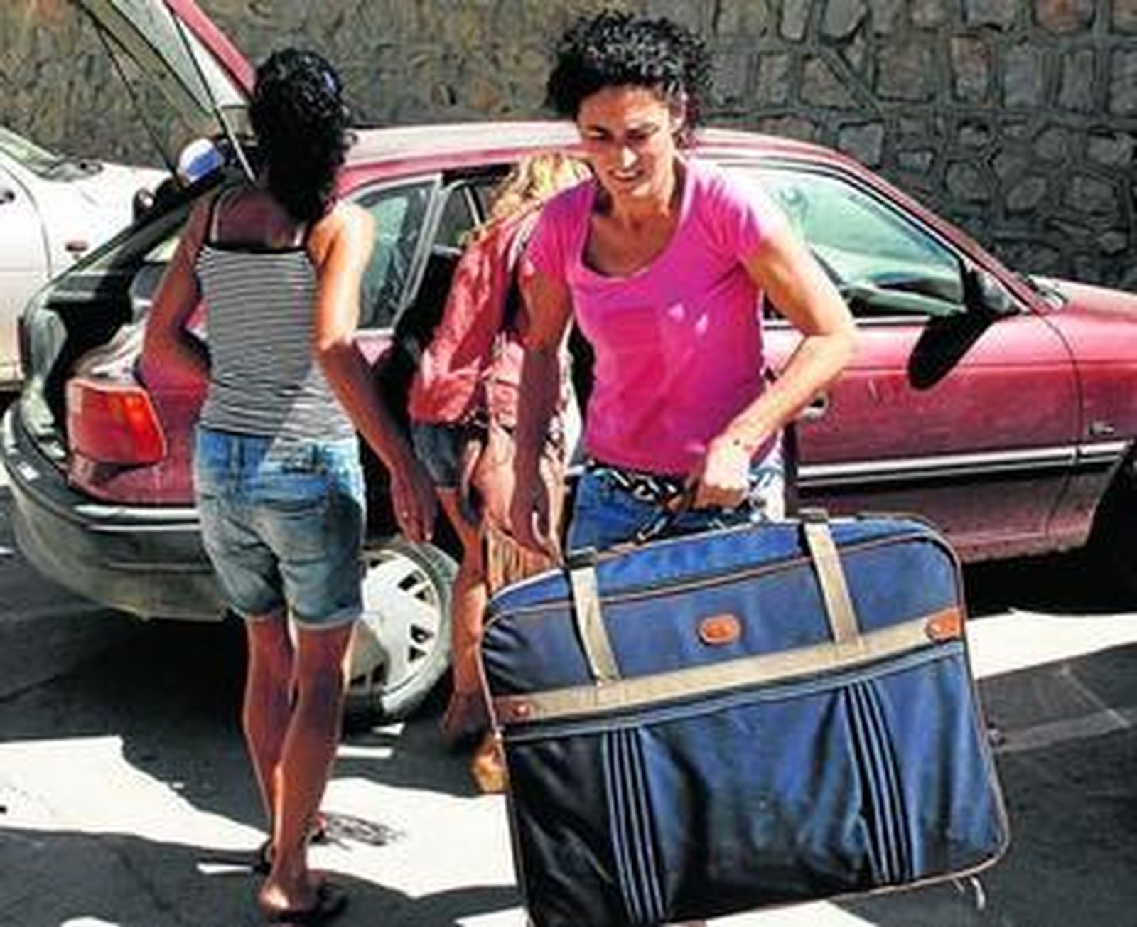 Vecinos de Alcalá, temporeros en Francia, en 2008, junto al monumento al emigrante que hay en su pueblo.