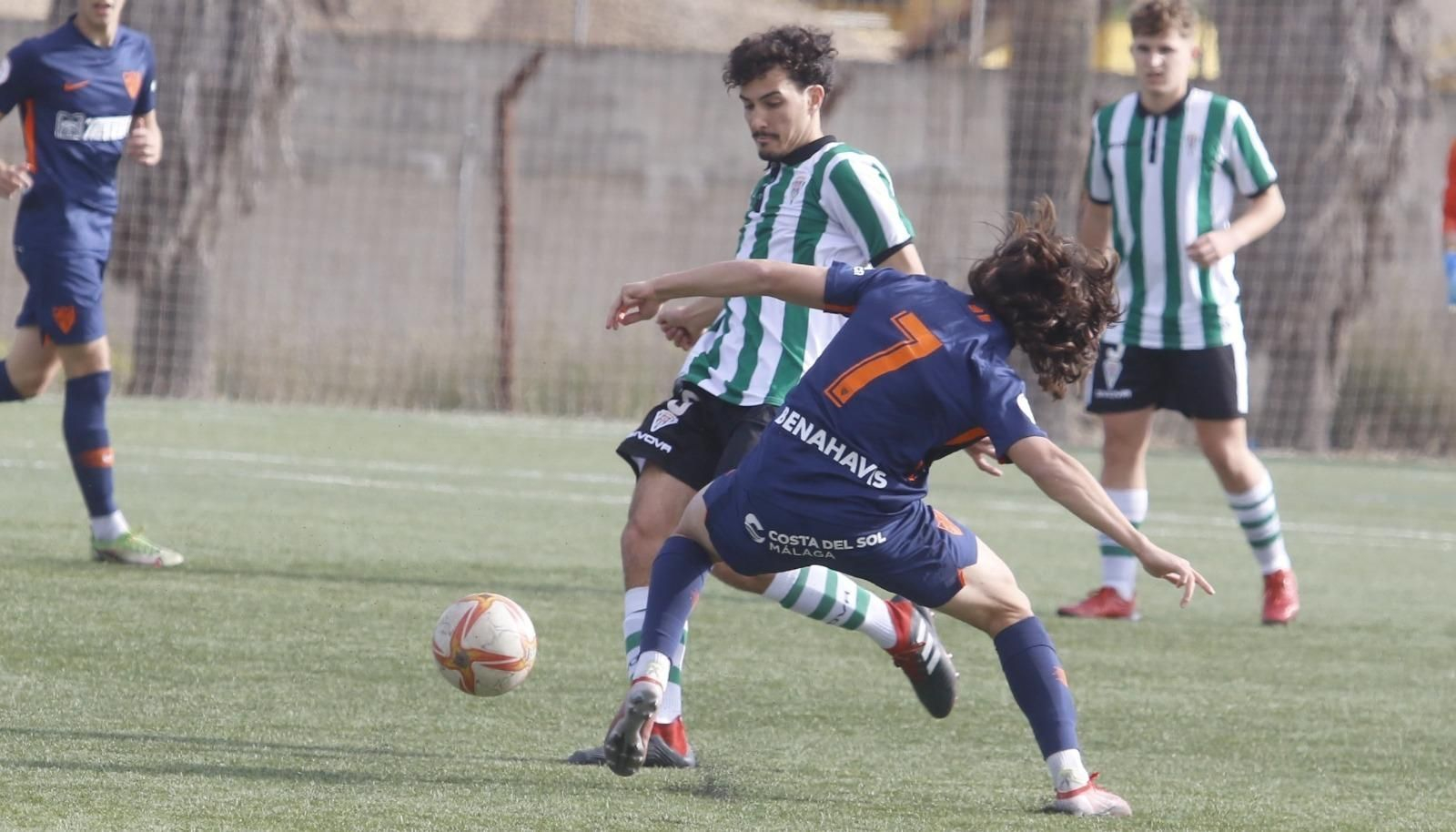 Cachorro, del Córdoba CF juvenil,  mueve el balón ante la presión del Málaga.