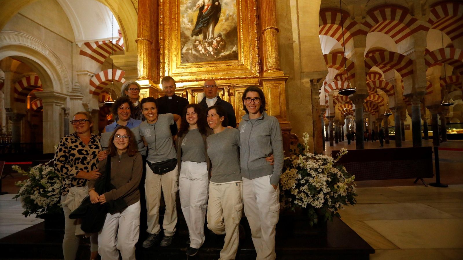 Las restauradoras posan con los responsables del Cabildo Catedral de Córdoba.