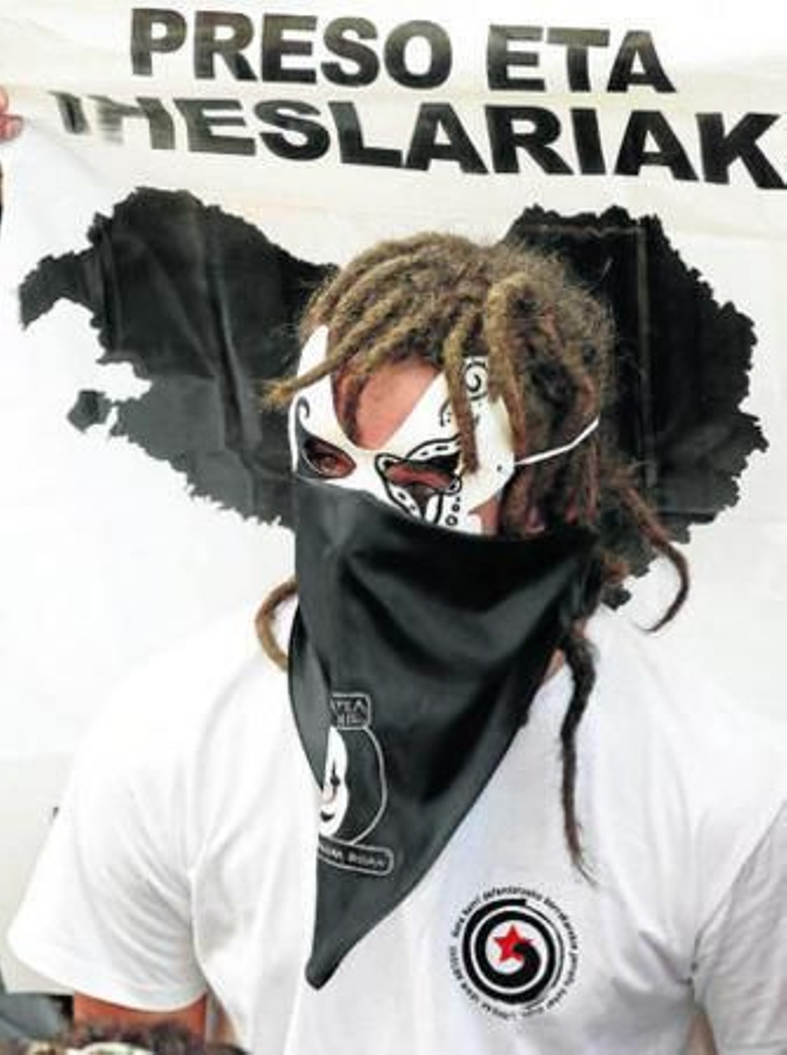 Un joven oculta su rostro en una manifestación en favor del acercamiento de los reclusos.