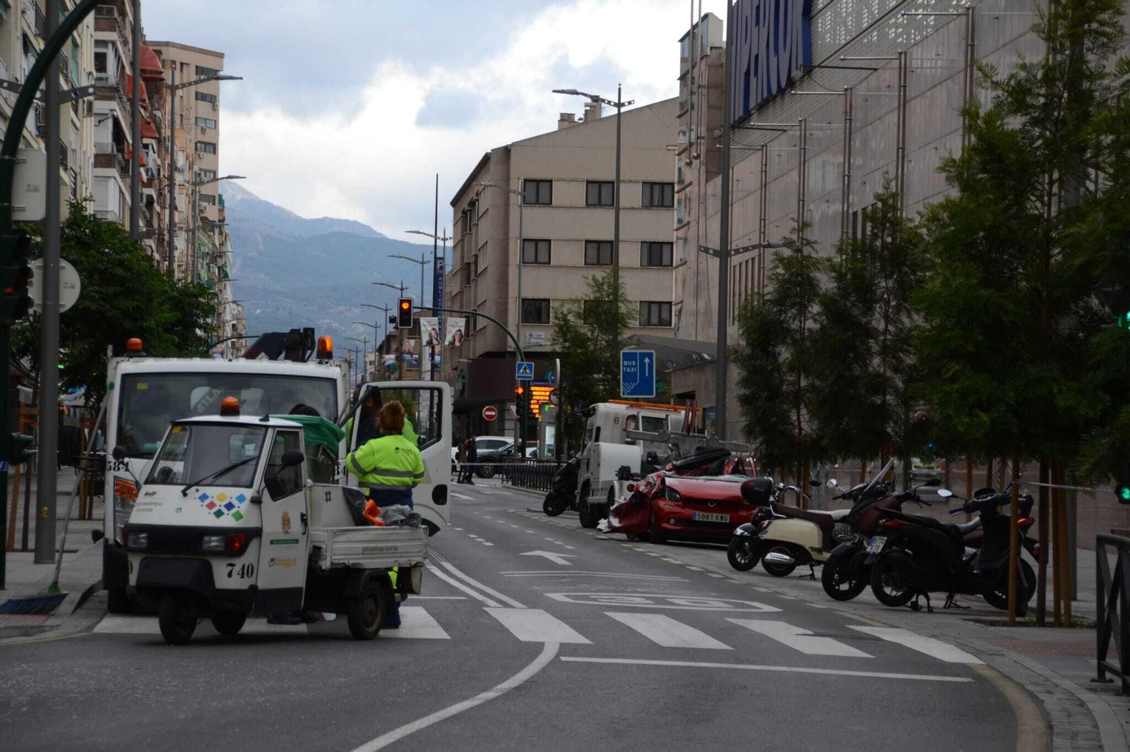 Una mujer resulta ilesa tras caer sobre su vehículo la carga de un camión grúa, en imágenes