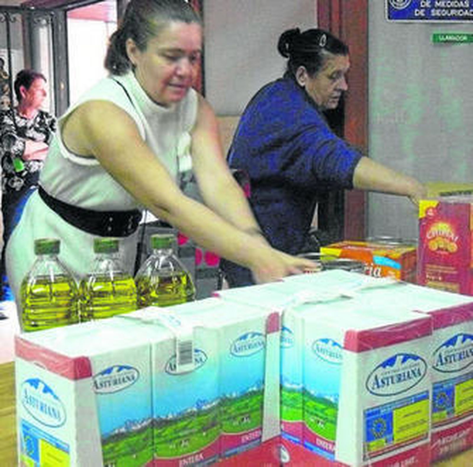 Vecinos del barrio de Pescadería acuden a la sede de la asociación a recoger alimentos.