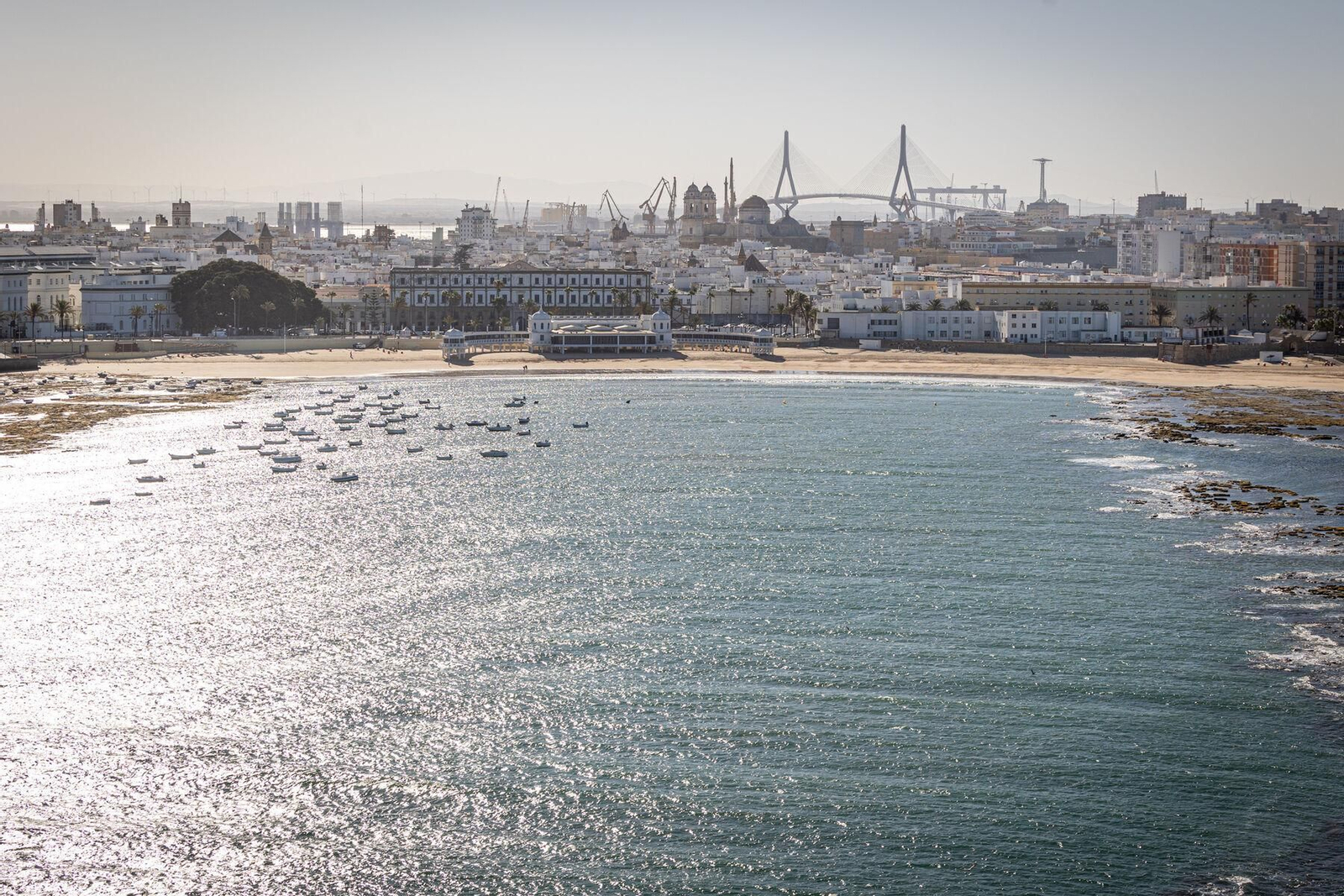 Foto aérea de la playa de La Caleta, con la ciudad al fondo.