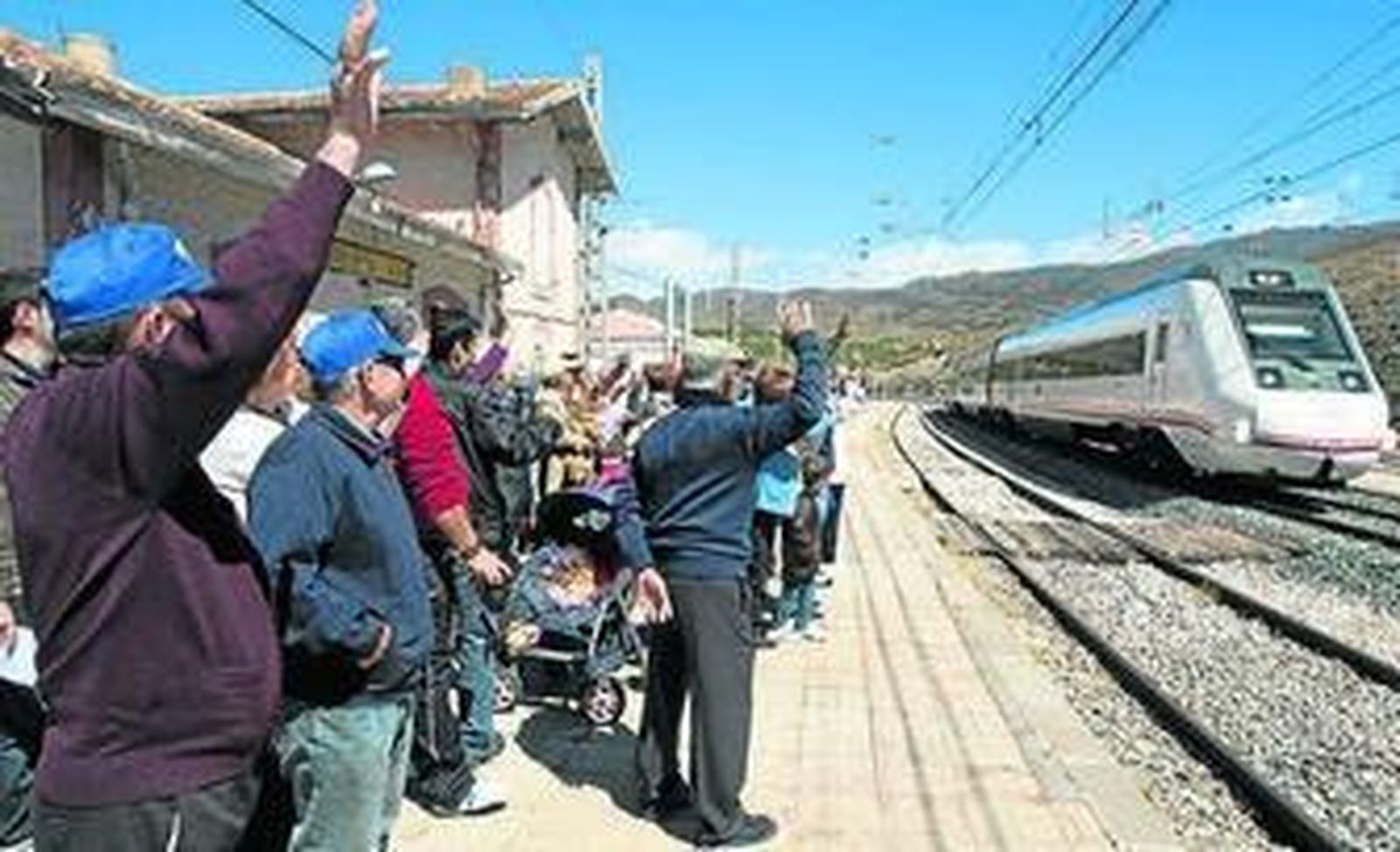 Los vecinos saludan al tren que viene de Granada.