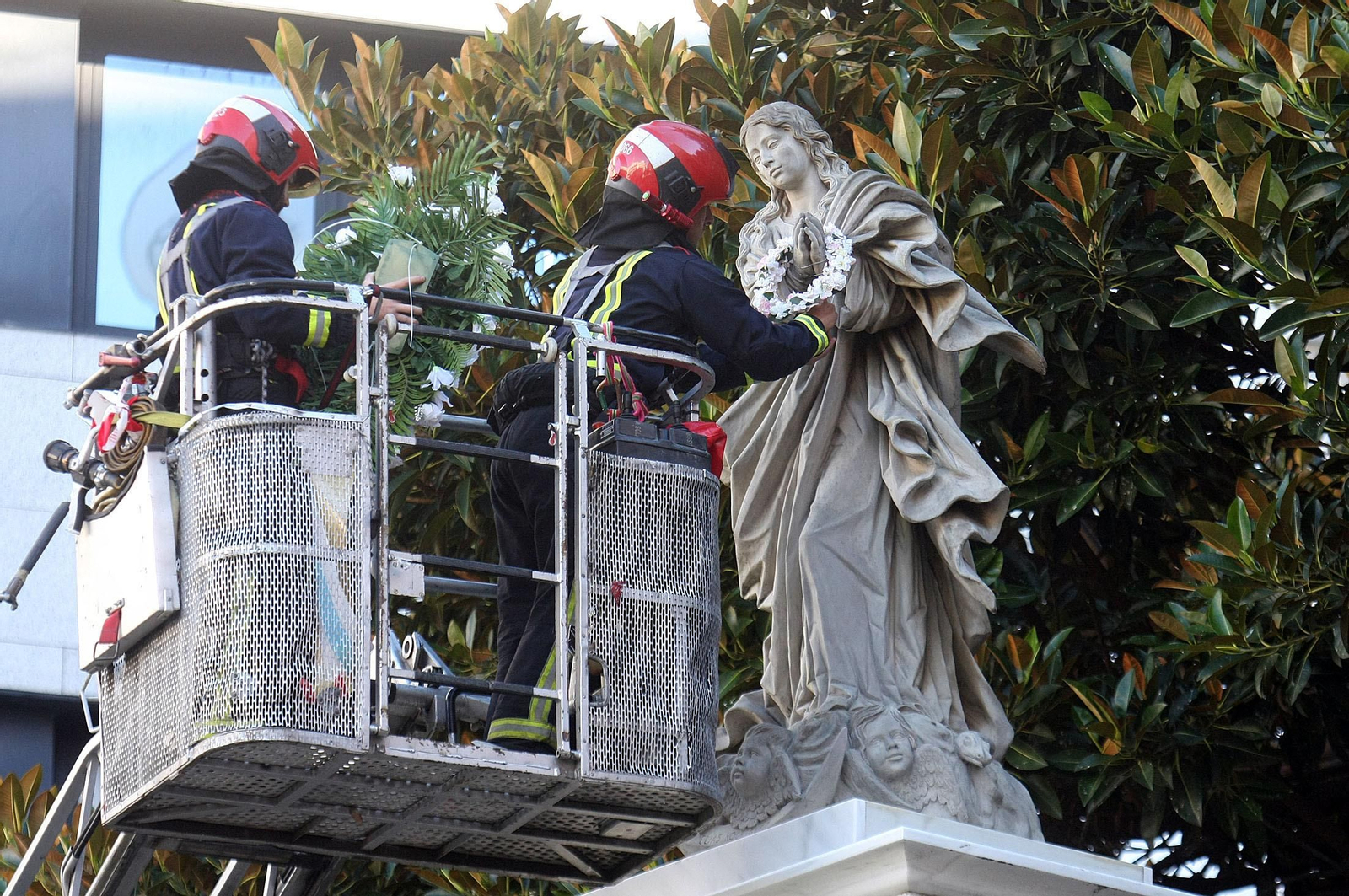Los bomberos, en el momento de colocar la corona de flores a la Inmaculada.