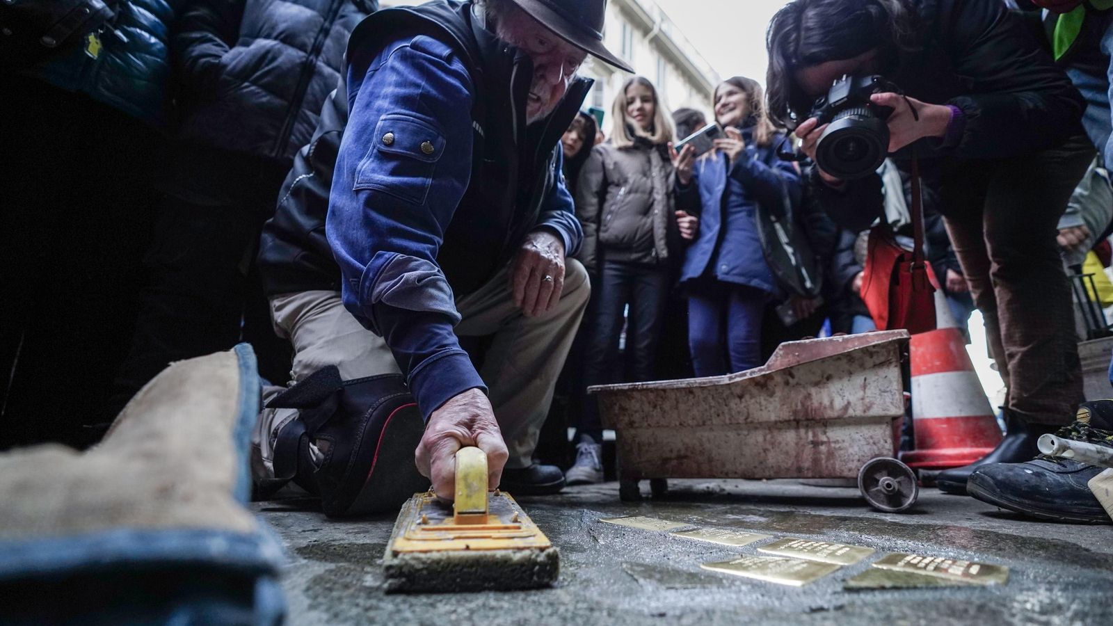 Gunter Demnig durante la colocación de unas piedras de la memoria en Turín