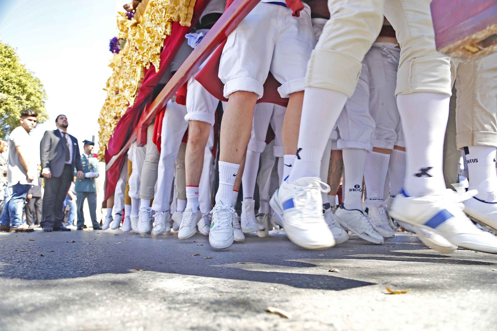 La cuadrilla de costaleros del Soberano Poder, levantando con fuerza el paso en los primeros compases de su estación de penitencia.