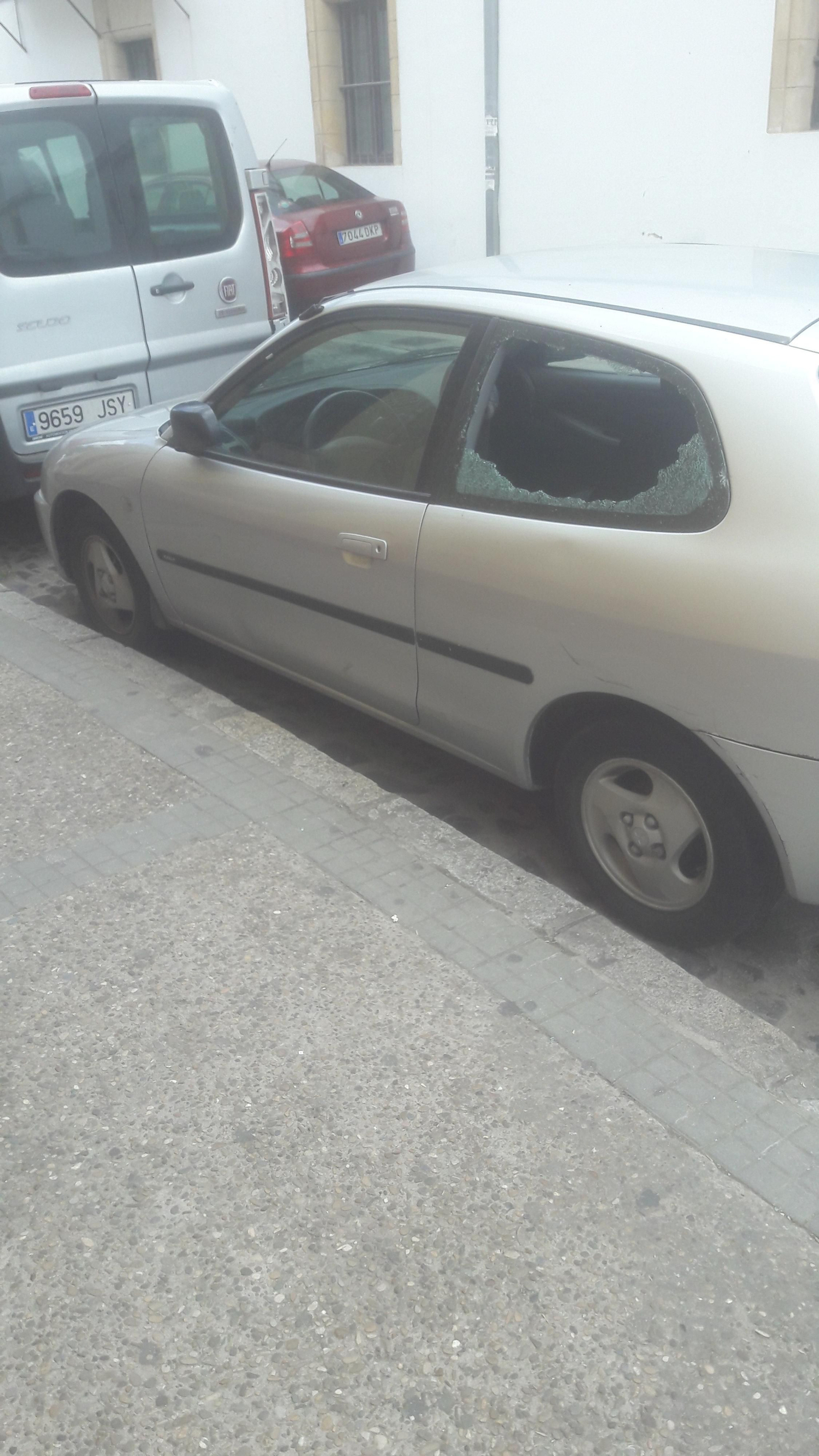 Un coche con un cristal partido días atrás en la calle Clavel.