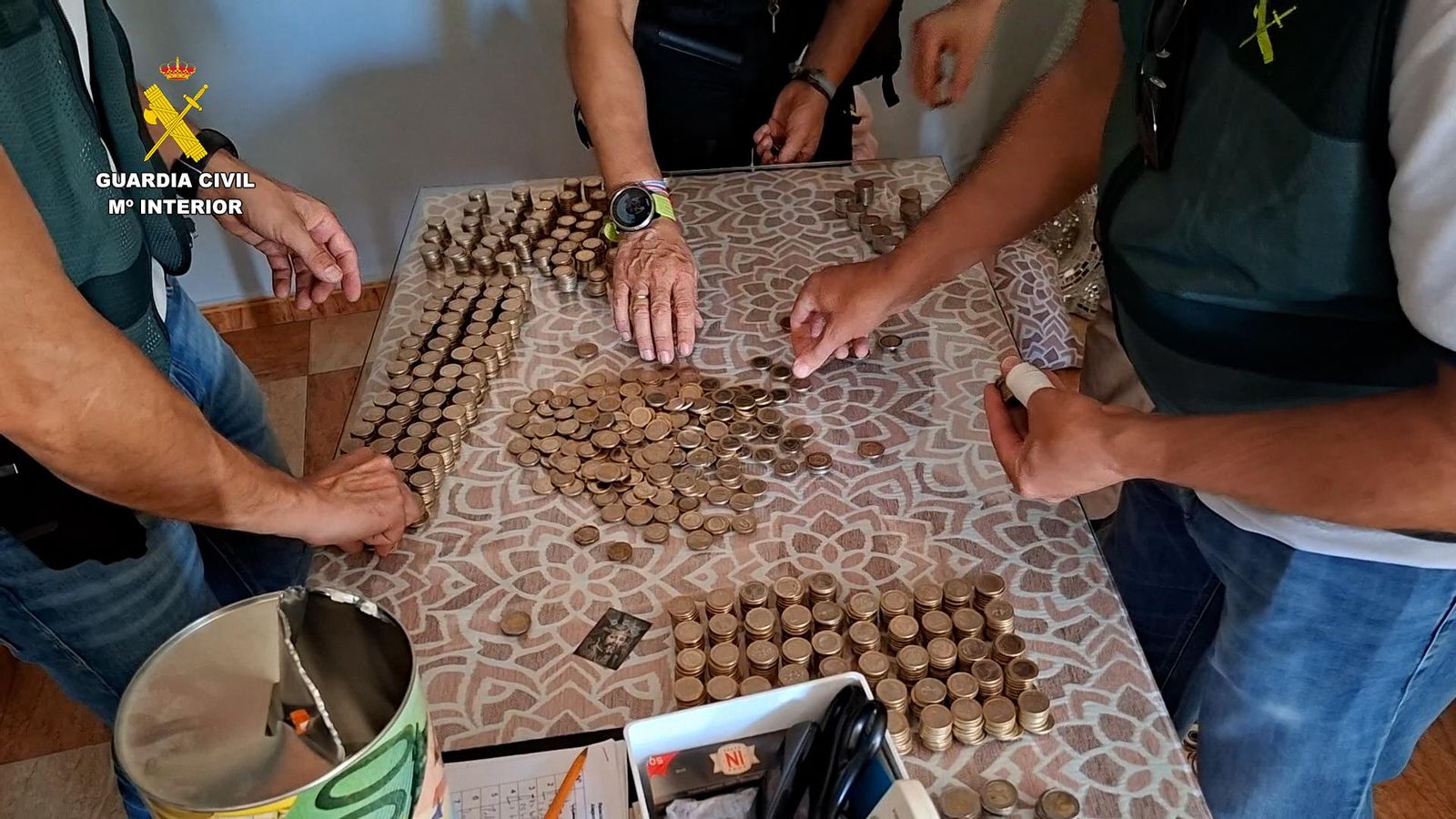 La Guardia Civil cuenta las monedas requisadas en Baena.