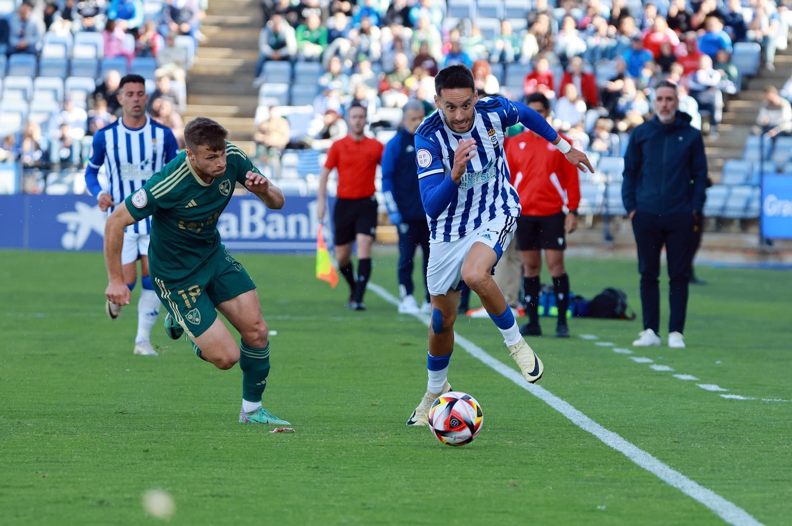 Dani Perejón presiona a Iago Díaz que conduce el balón por la banda en el Recre-Linares de la 23/24.