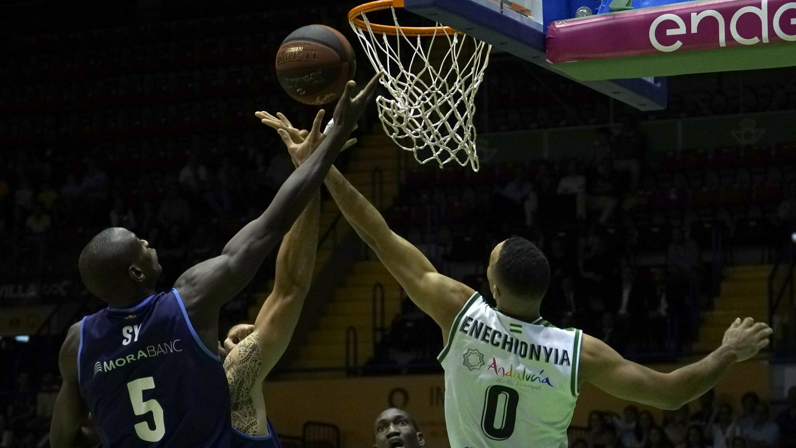 Obi pugnapor un rebote con Sy y Nacho Llovet.