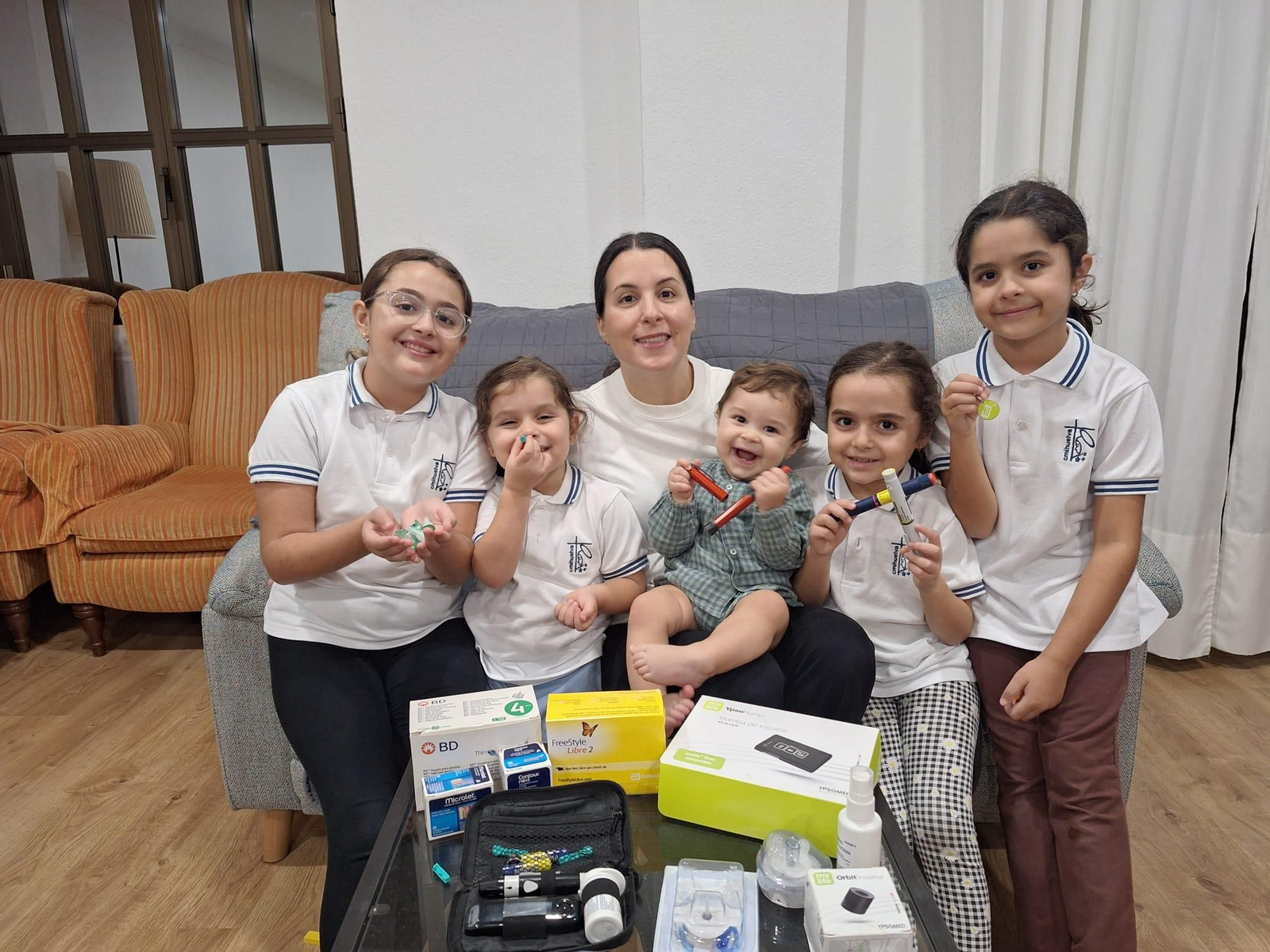 Marta Delgado con sus hijos y todos los dispositivos necesarios para controlar su diabetes.