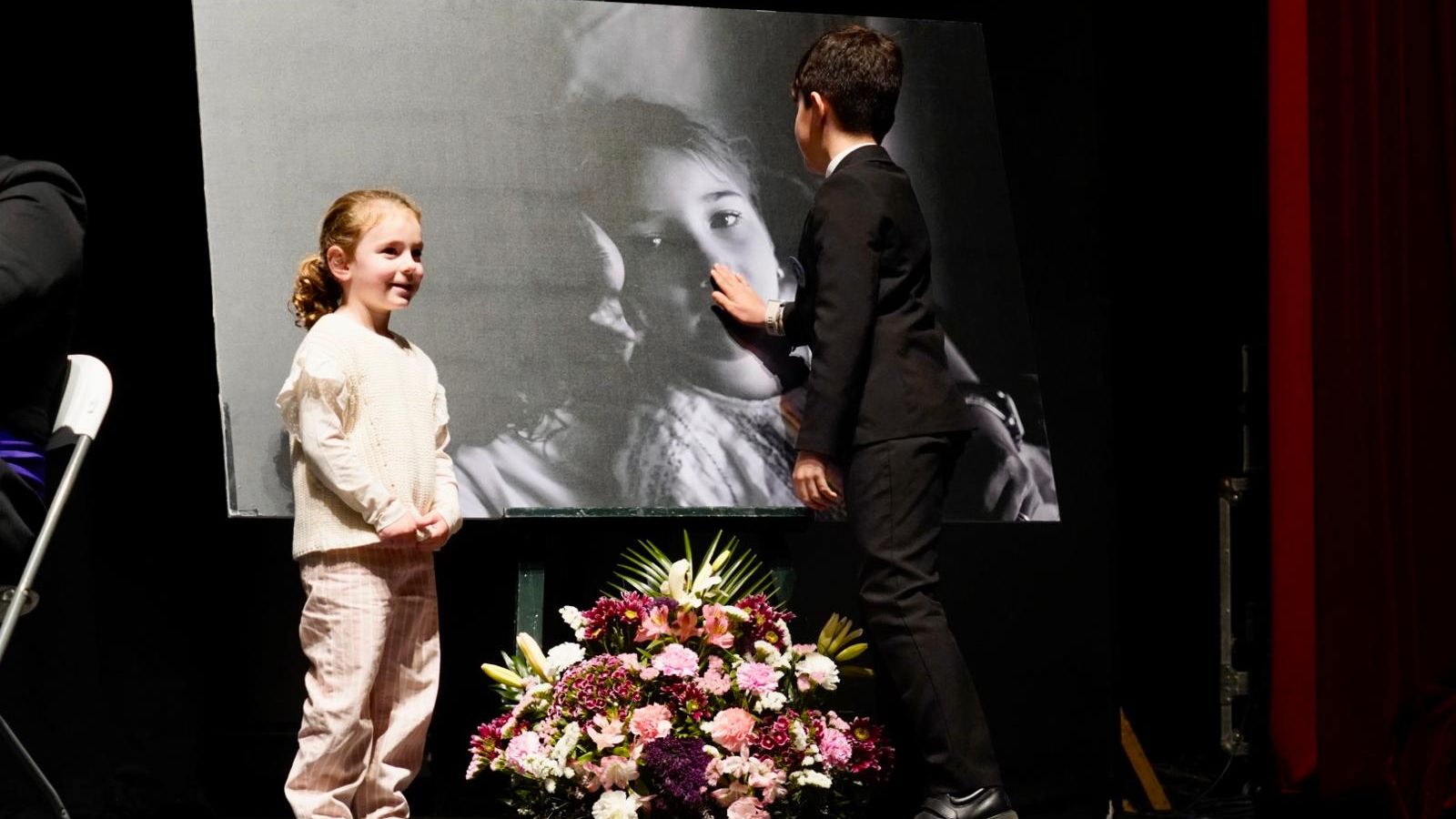 Pequeños familiares ante una foto de Ariadna.