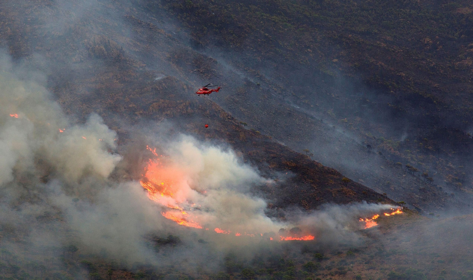 Un helicóptero en las tareas de extinción del fuego en Sierra Bermeja. Un helicóptero en las tareas de extinción del fuego en Sierra Bermeja.