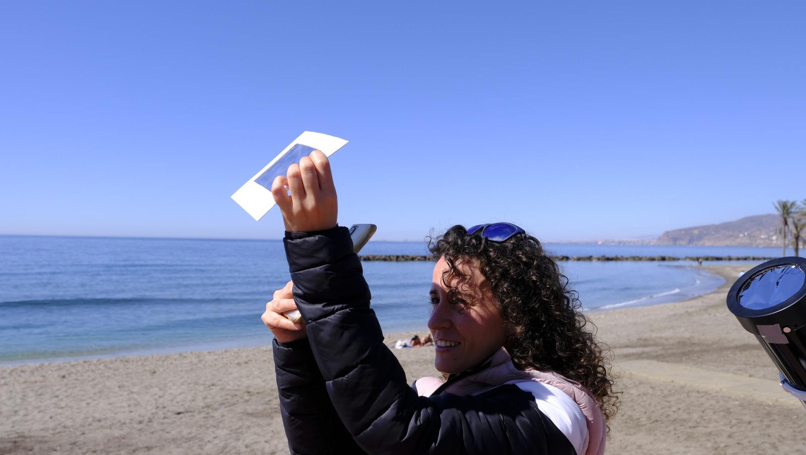 Almería observa el eclipse solar desde el Paseo Marítimo, en imágenes