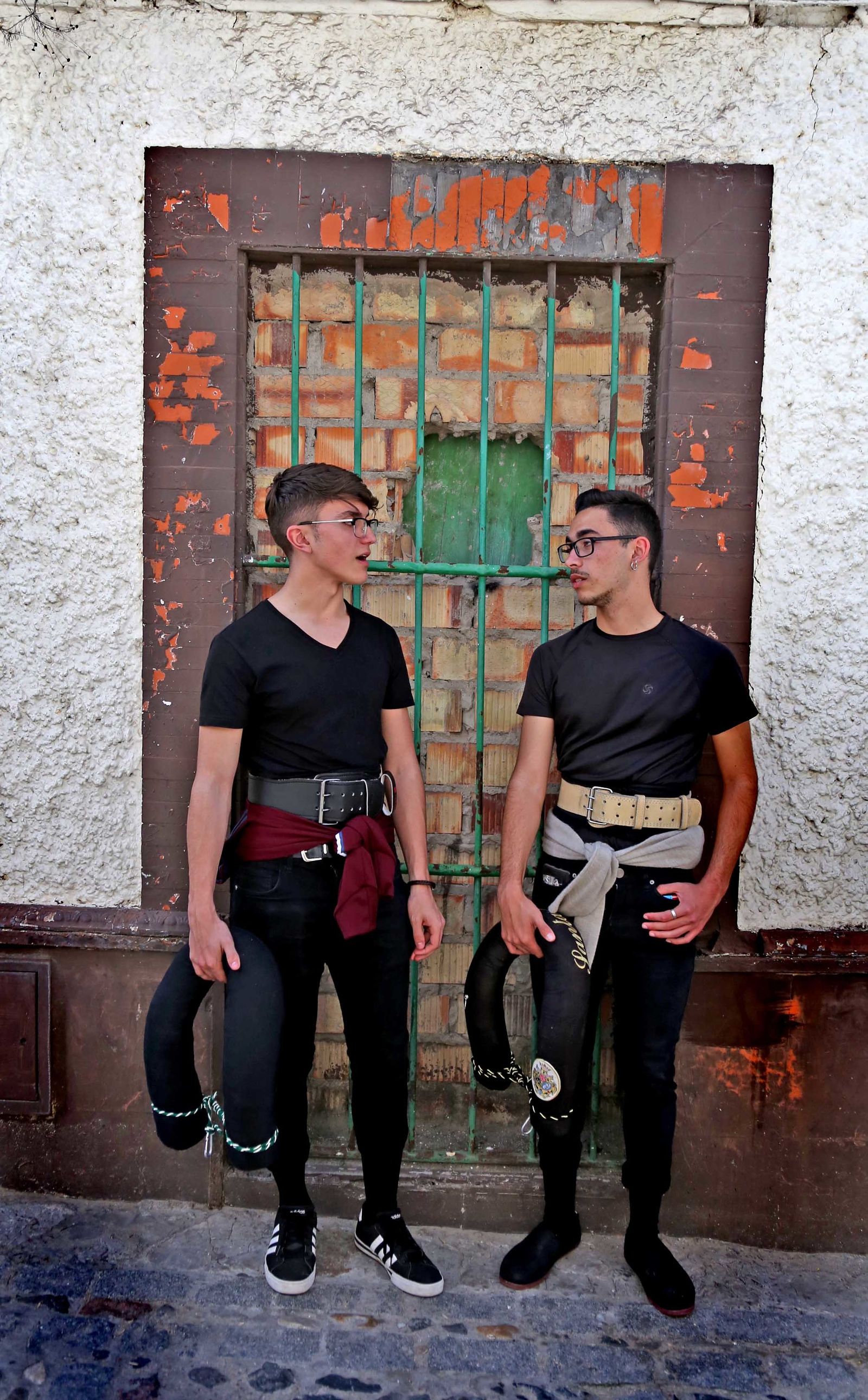 Dos costaleros de la hermandad de Santa Marta conversan en las estrechas calles de San Mateo a la espera de hacer el relevo en su paso.