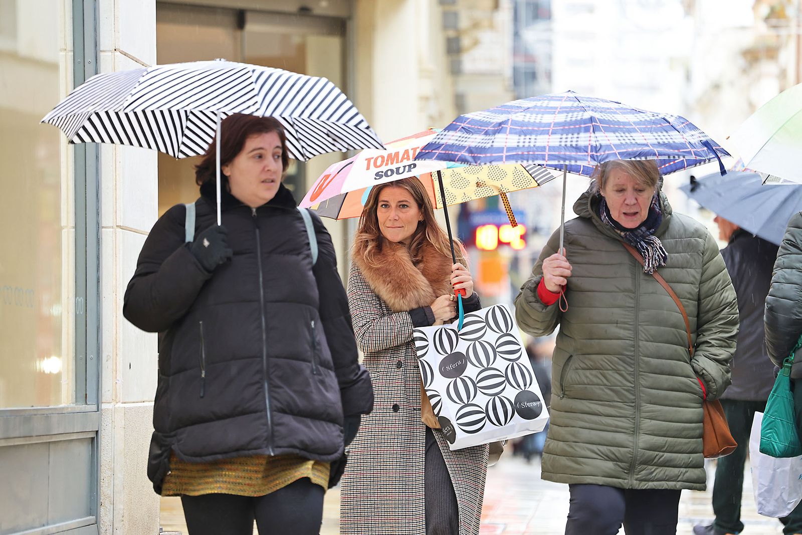 Las calles de la ciudad se inundan de paraguas en la invernal mañana de sábado