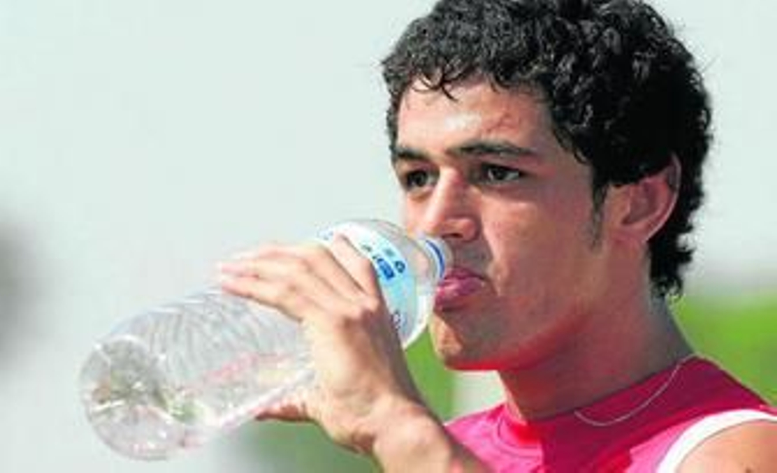 Lautaro Acosta se refresca durante un receso en un entrenamiento.