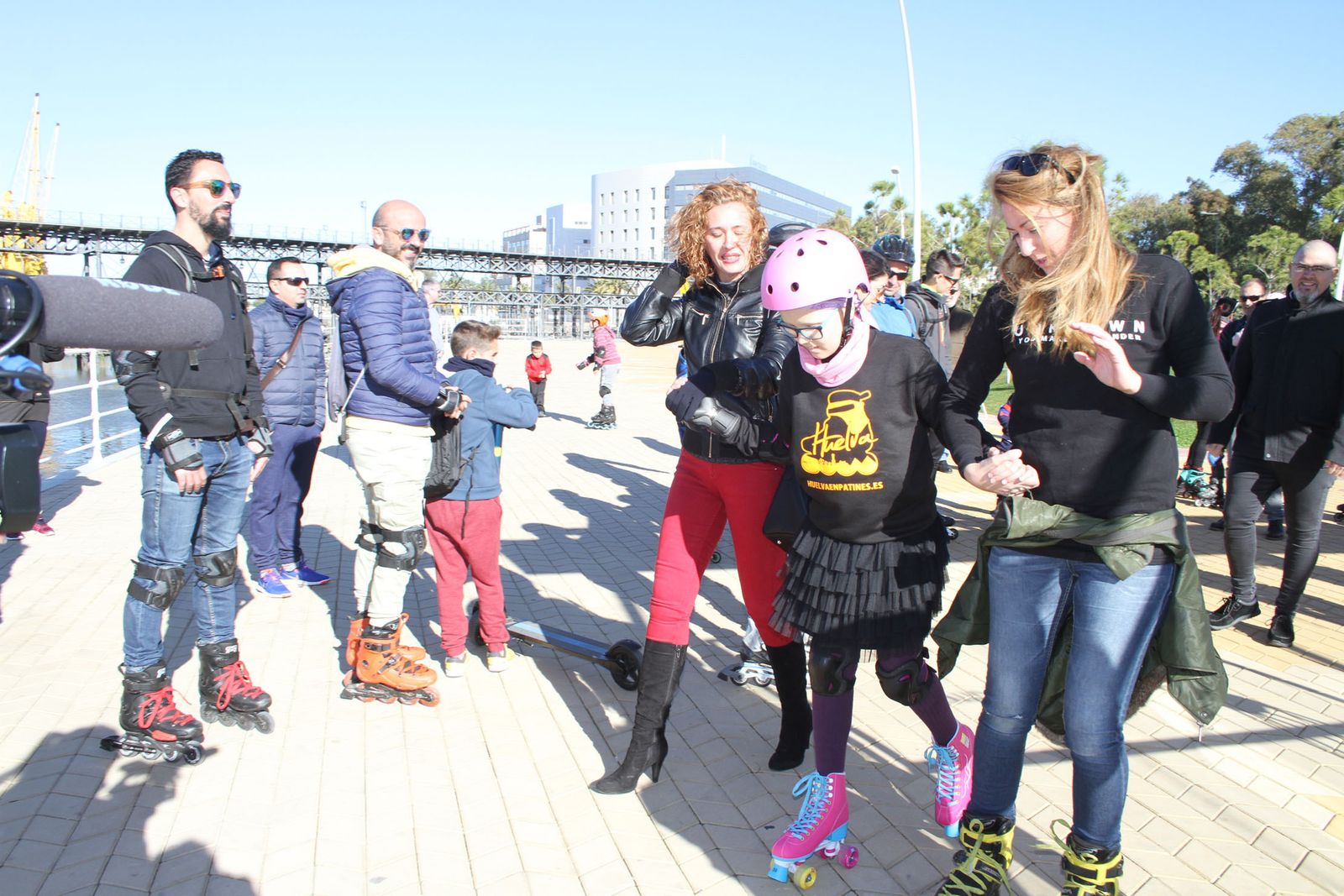 La niña onubense, acompañada por otros amantes del patinaje en el Paseo de la Ría.