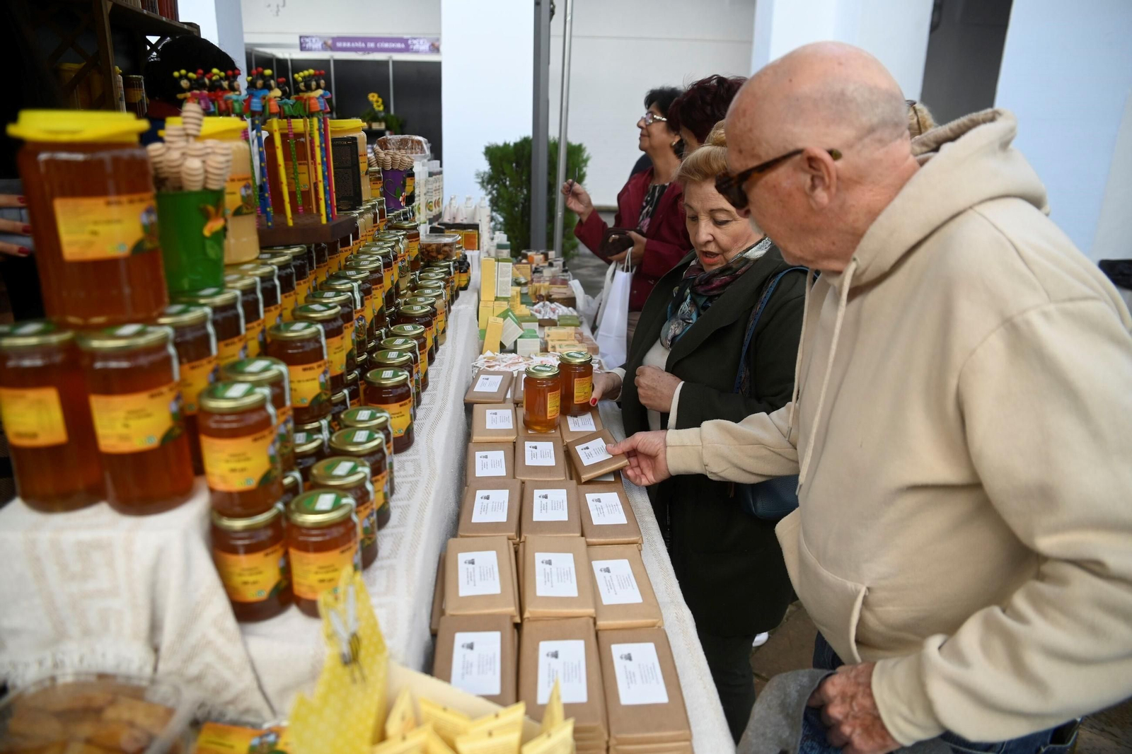 Varias personas observan los productos de un estand de Expomiel 2025.