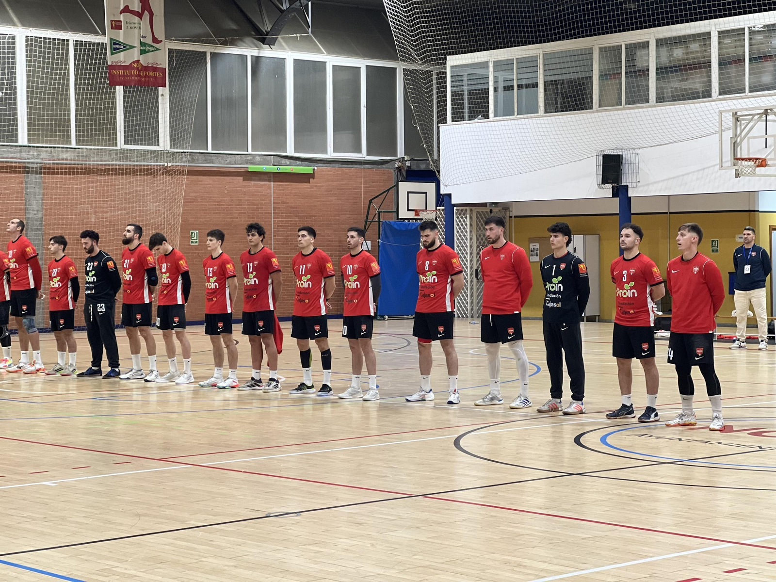 Los jugadores del Cajasol Sevilla BM Proin, durante el minuto de silencio antes del partido contra el Helvetia Anaitasuna.