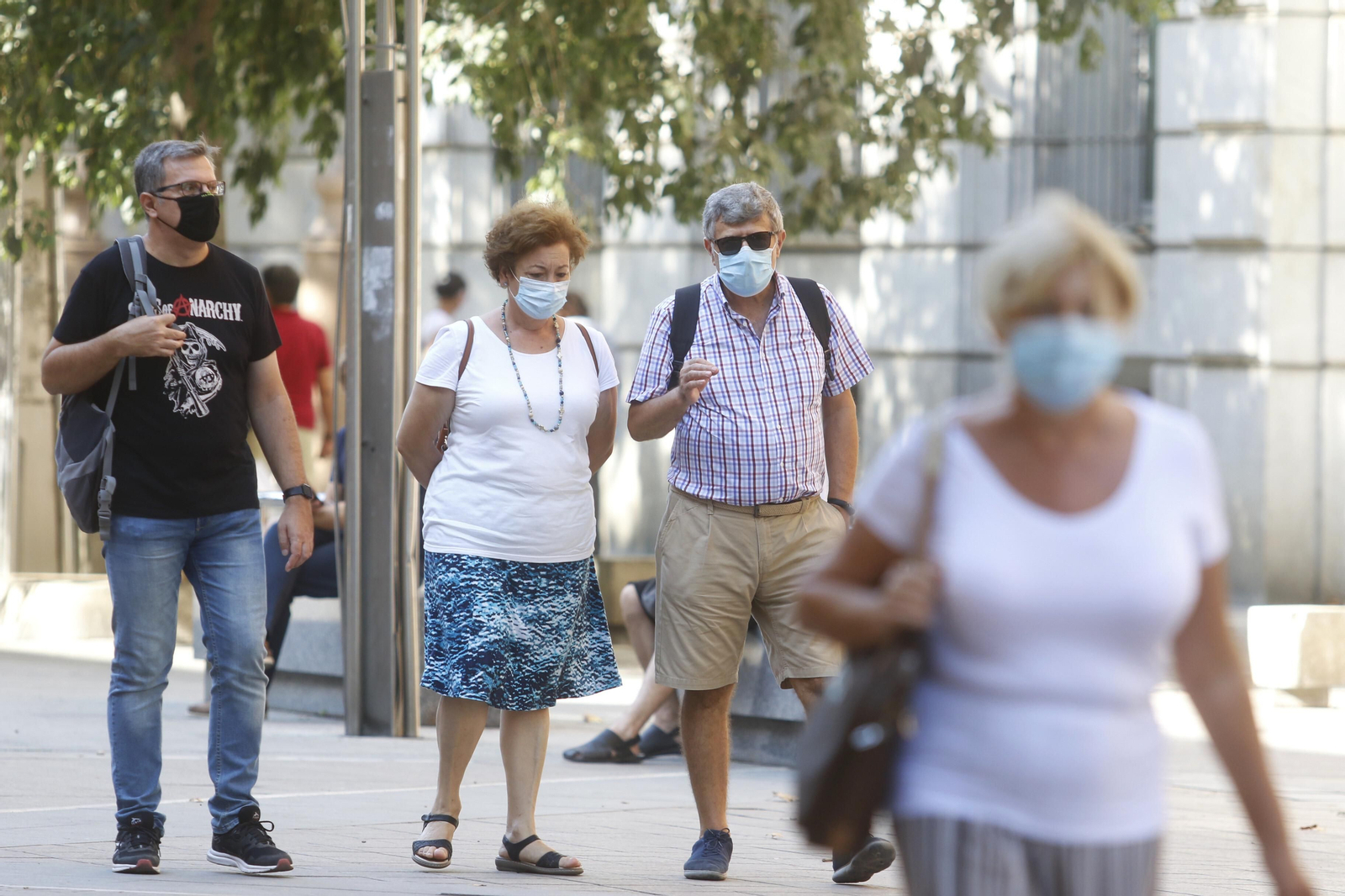 Varias personas caminan con mascarilla por el bulevar del Gran Capitán.