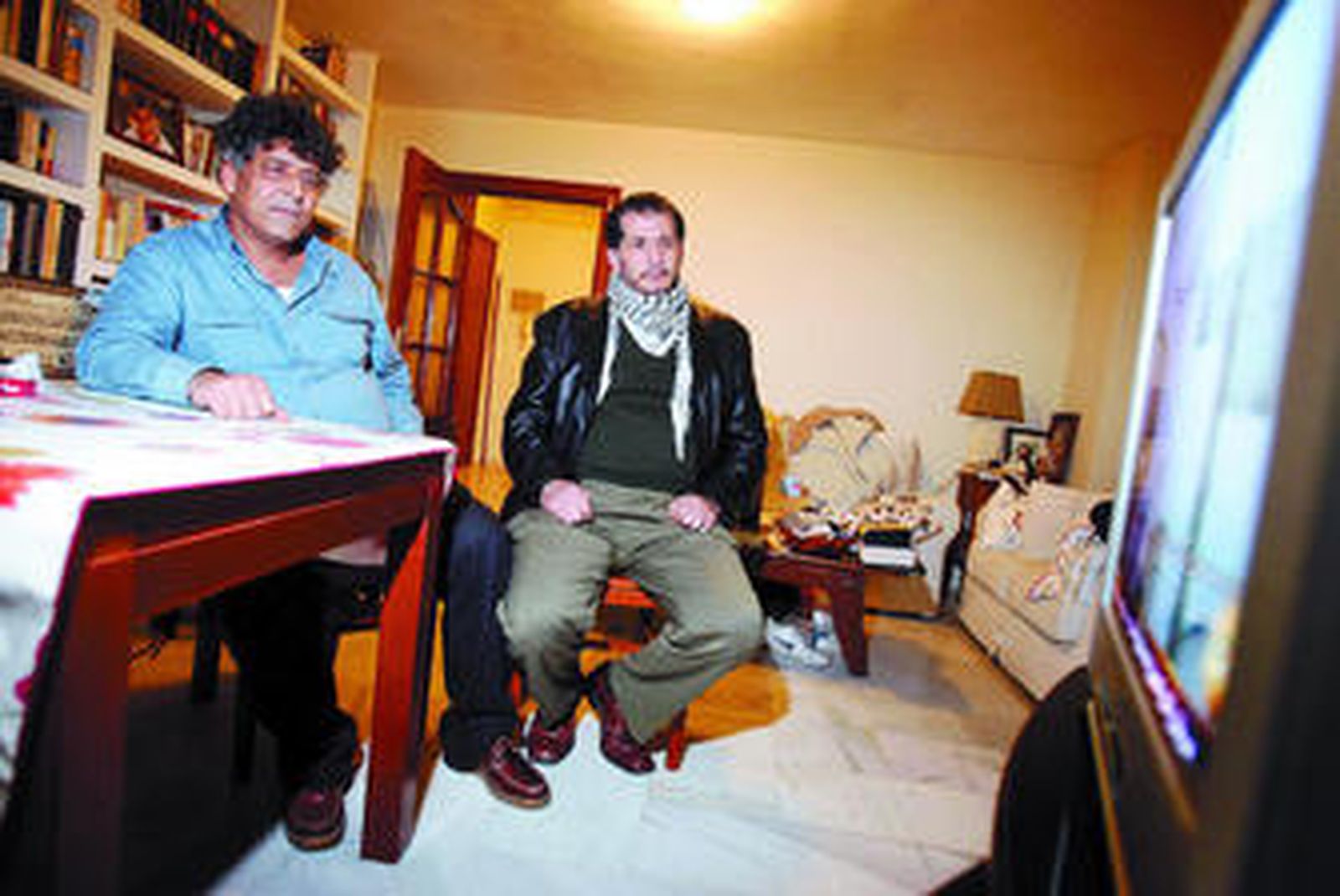 Adel Tawil (izda.) y Adib Nazal ayer tarde, en Fuengirola, siguiendo por televisión las últimas noticias sobre Gaza.