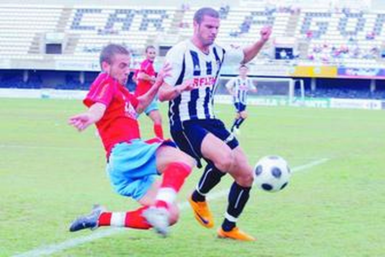 Nano aguanta la entrada de un rival en un partido en el estadio Cartagonova.