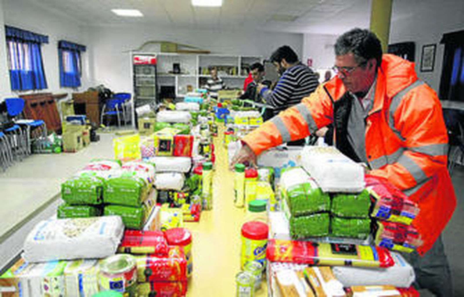 Miembros de la asociación preparan los alimentos momentos antes de repartirlos.