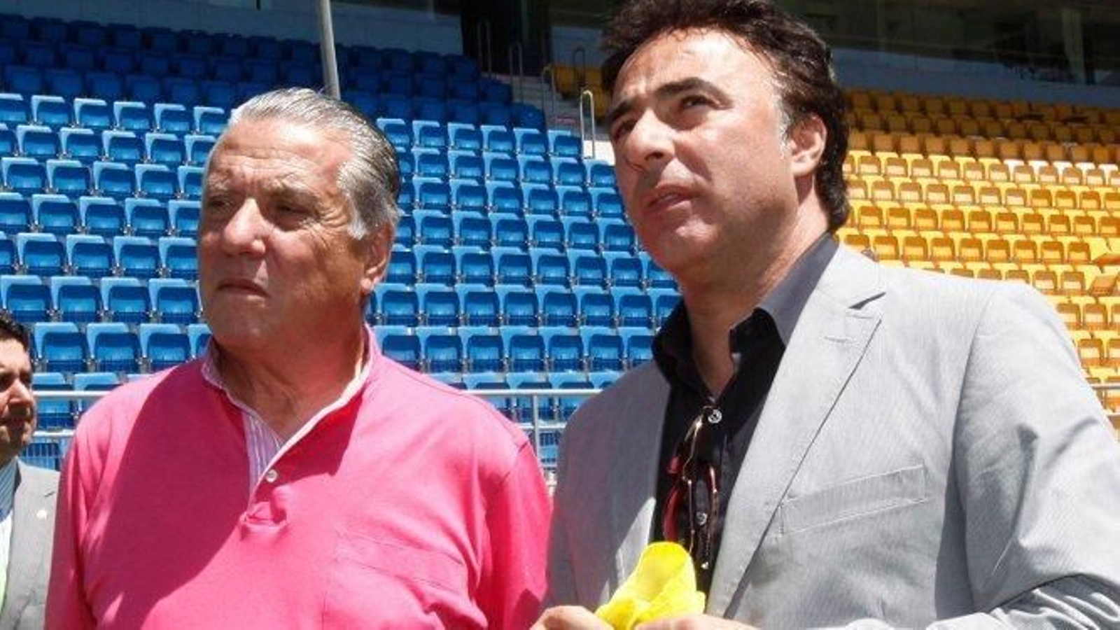 Quique Pina, en compañía de su padre, Juan José, sostiene una bandera y una bufanda del Cádiz.