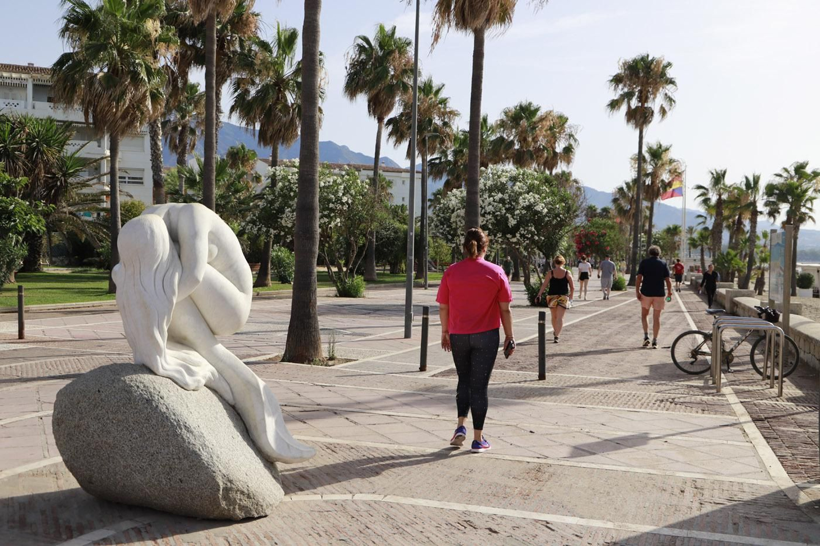 Varios viandantes en el paseo Alberto Vidiella  Tudores, en Puerto Banús.