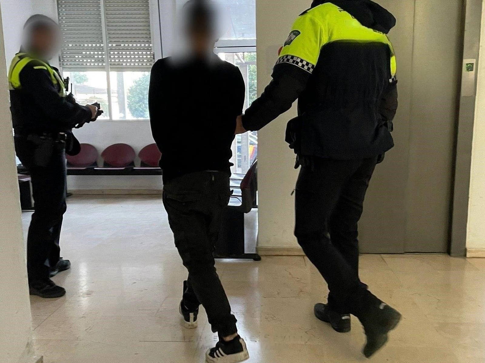 Un policía local con un detenido, en una imagen de archivo.