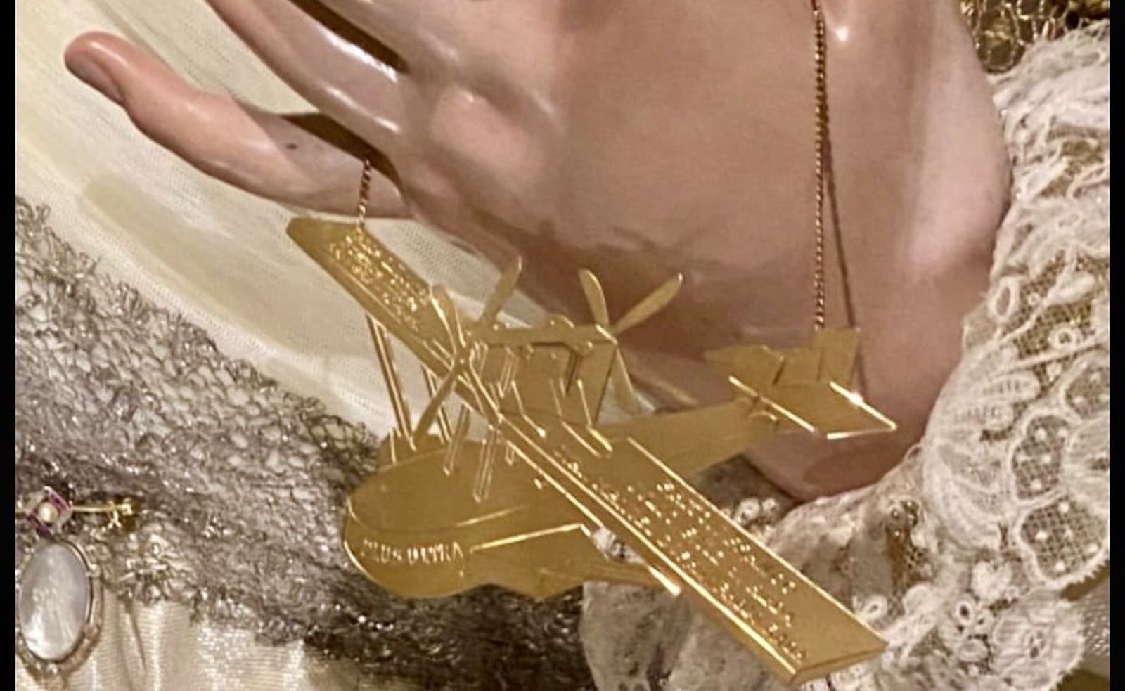 El avión de oro en la mano izquierda de la Virgen de Loreto.
