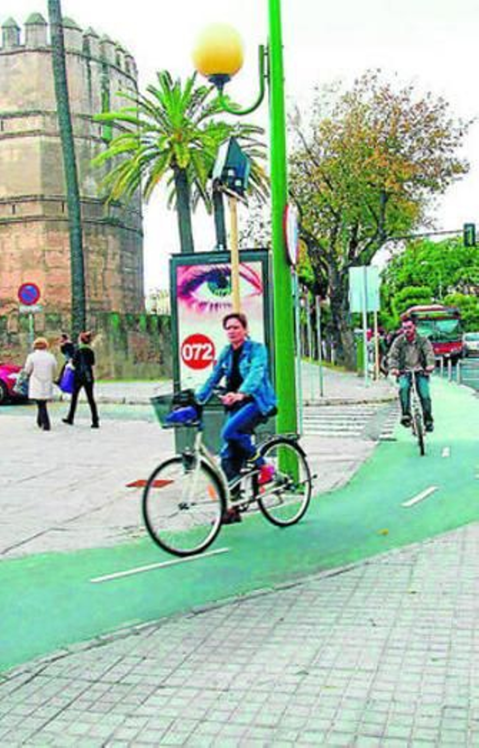 Dos ciclistas por el carril bici de la ronda histórica de la Macarena.