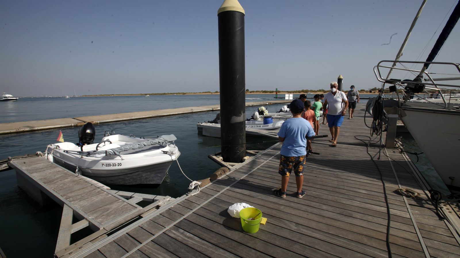 Los pantalanes de los clubes náuticos sirven de plataforma para pescar en mitad del río Piedras