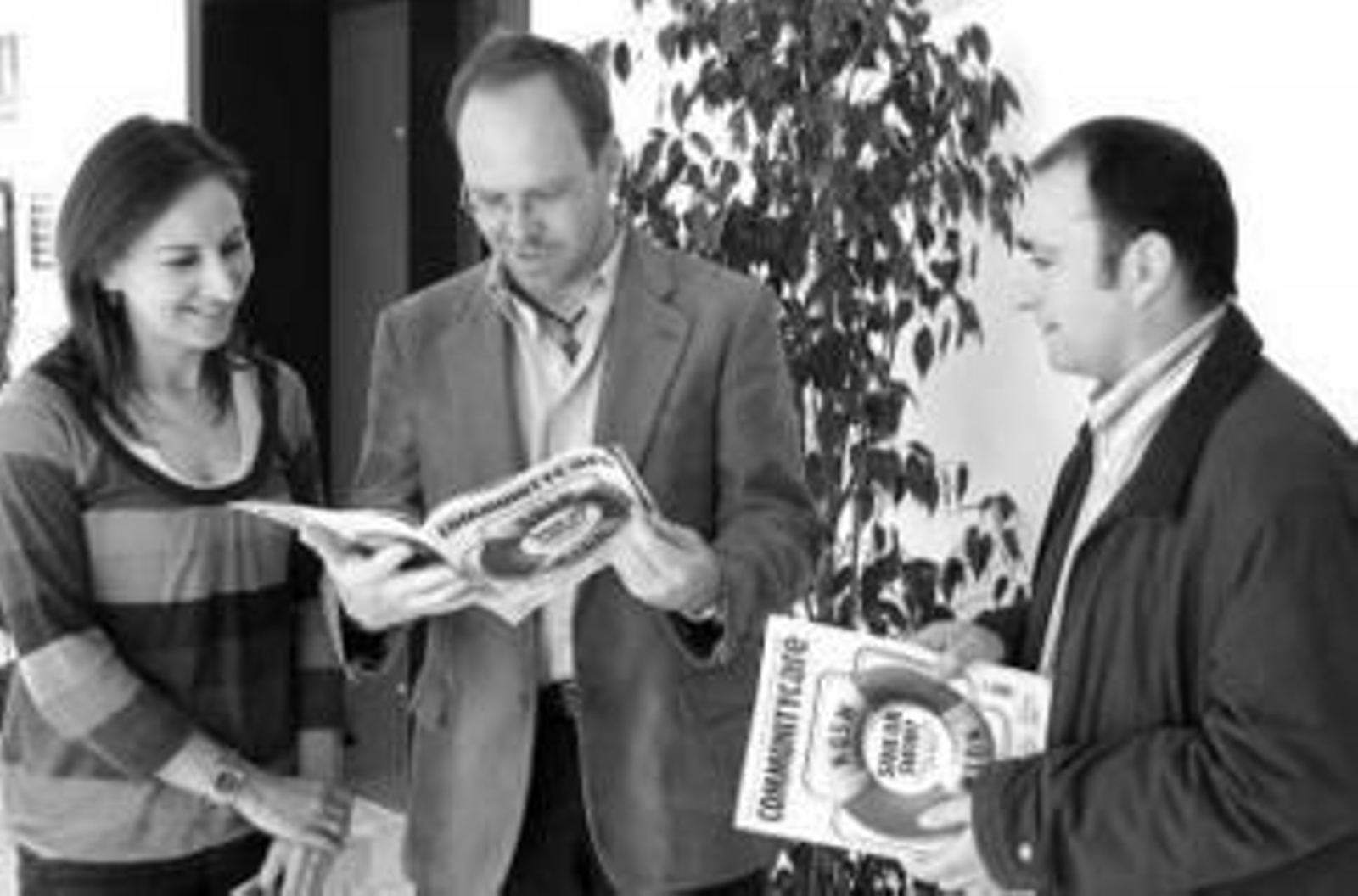 Los promotores del proyecto social leen la revista 'Community Care'.