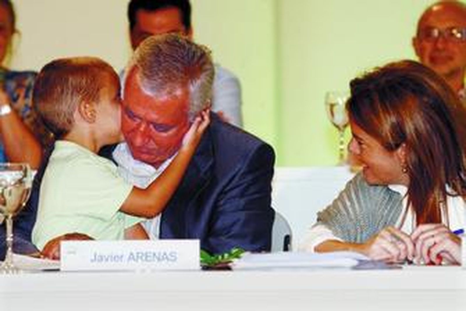 Javier Arenas recibe un beso de su hijo Carlos durante el congreso; a la derecha, Soraya Sáenz de Santamaría.